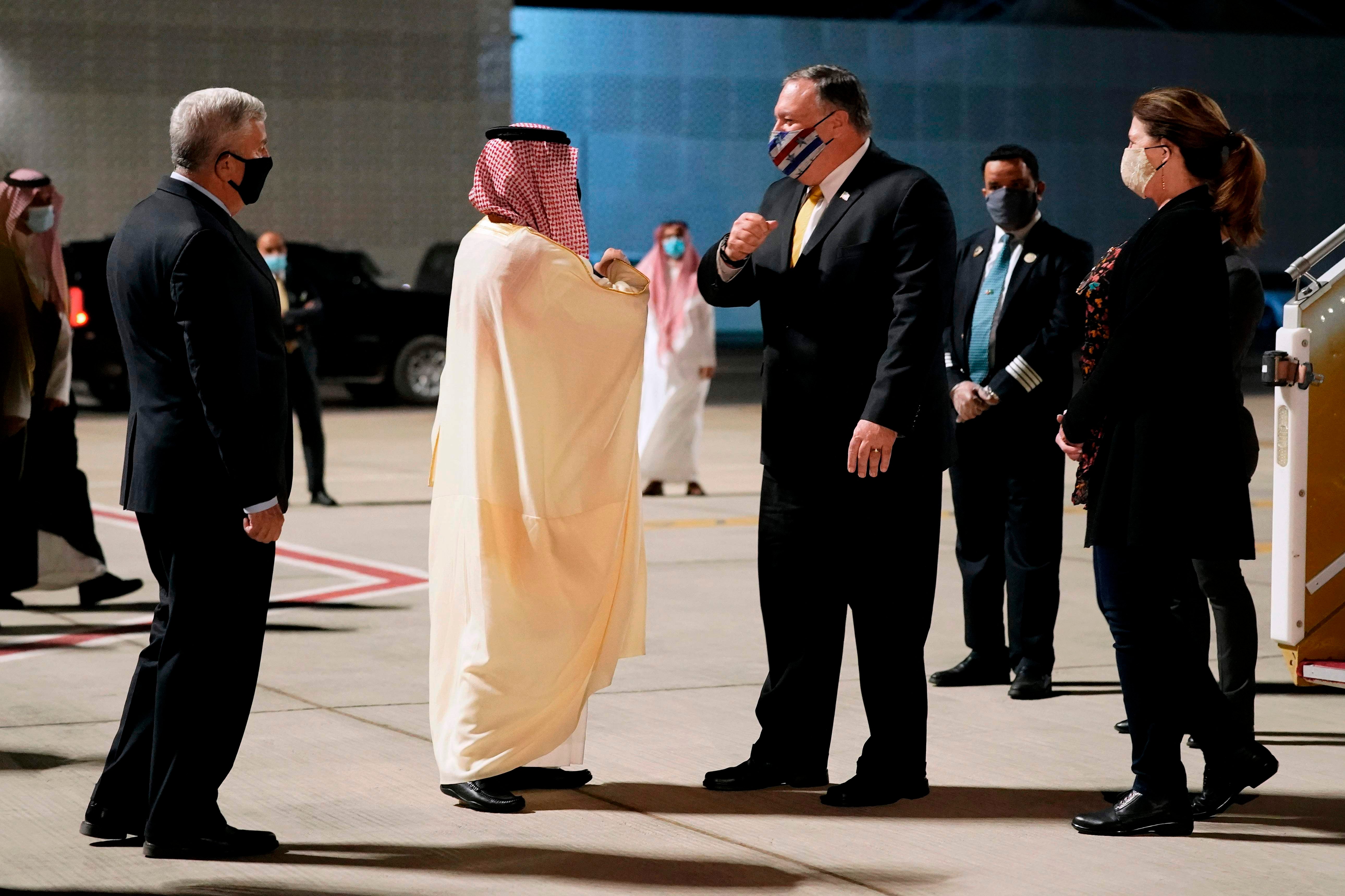 Faisal bin Farhan (centre left) greets Mike Pompeo in Neom on Sunday