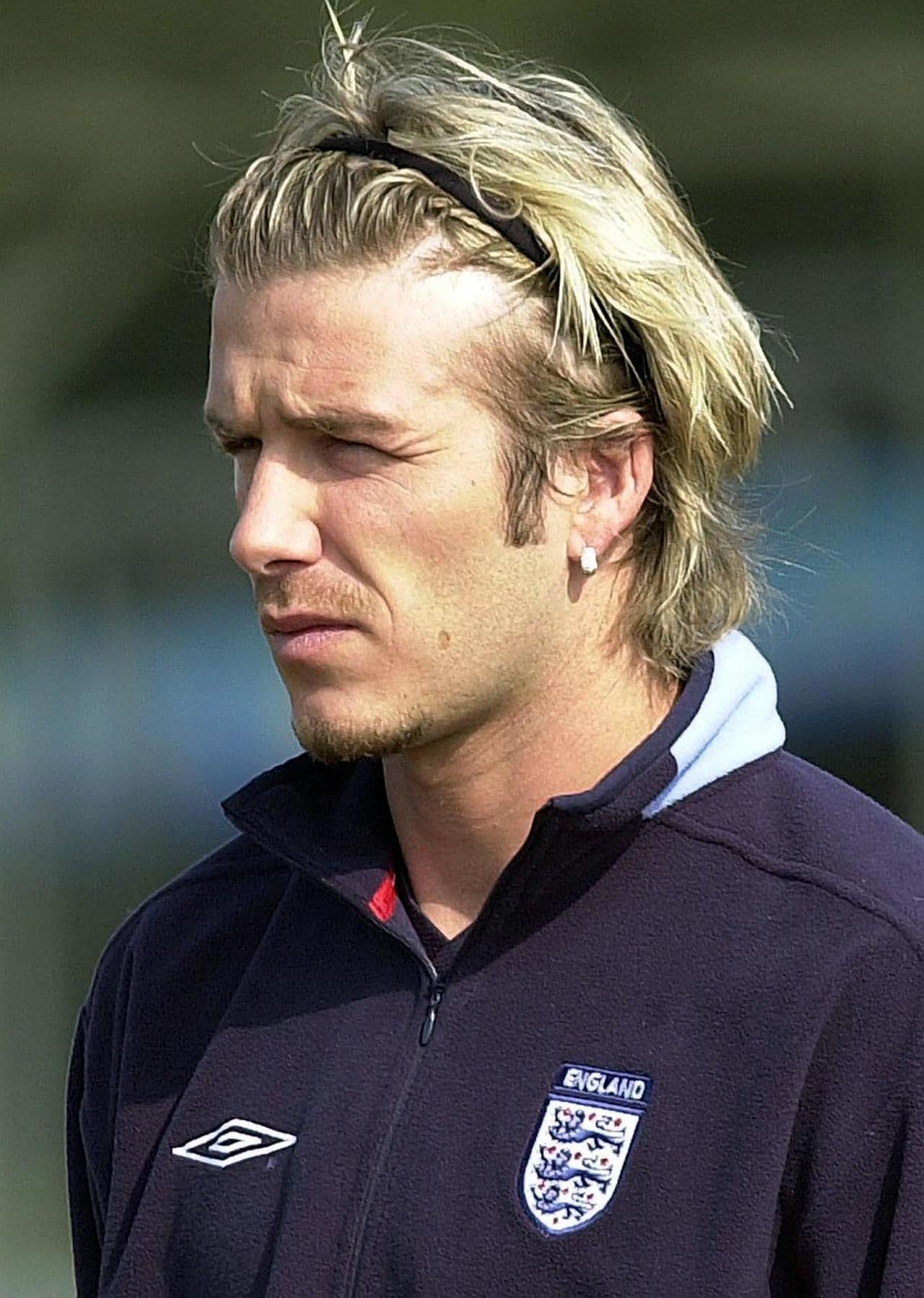 Beckham wore headbands on the pitch to get his long hair out of his face (Rebecca Naden/PA)