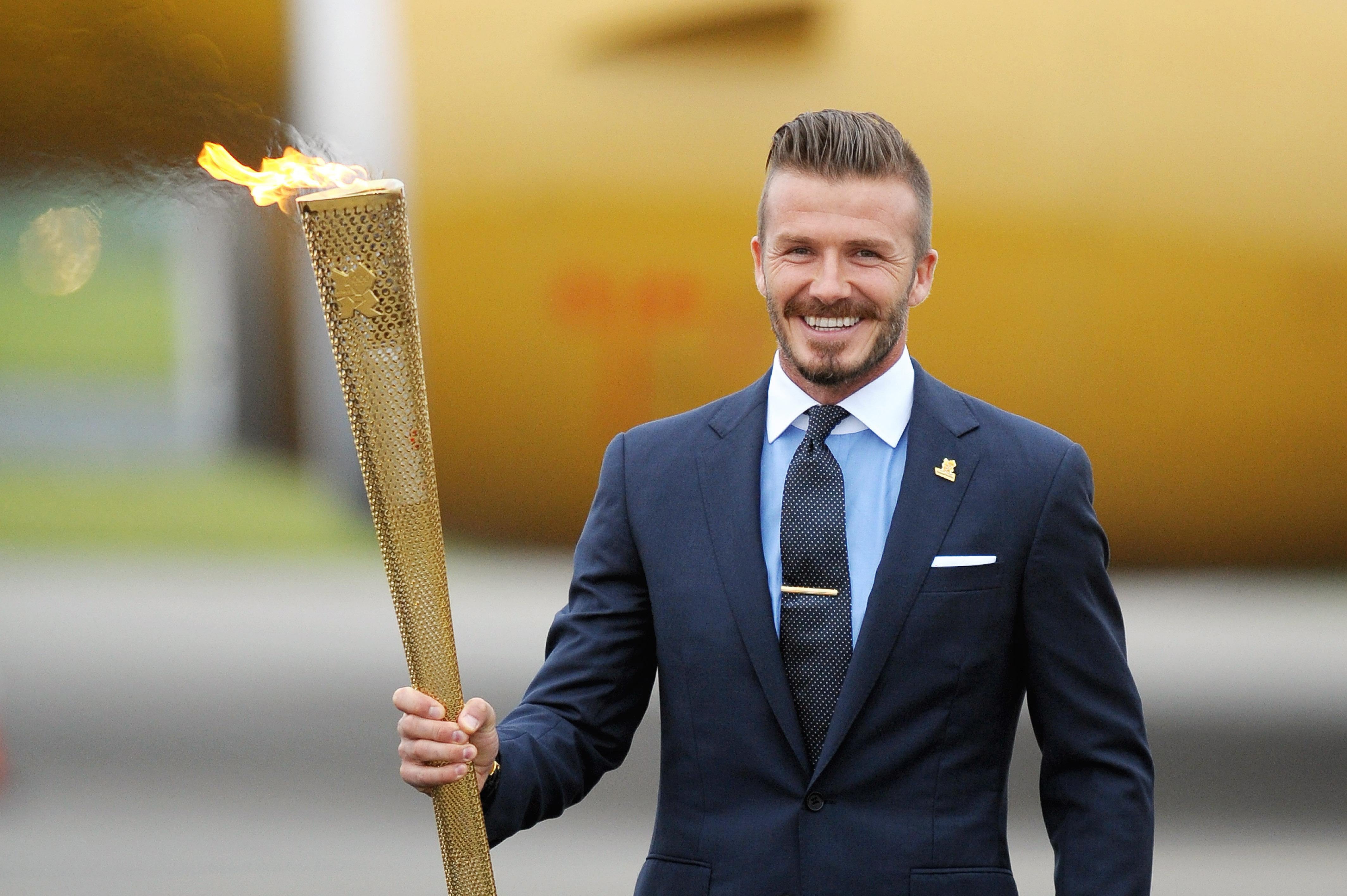 Beckham’s hair and beard was sharp and slick for the carrying of the Olympic flame (Tim Ireland/PA)