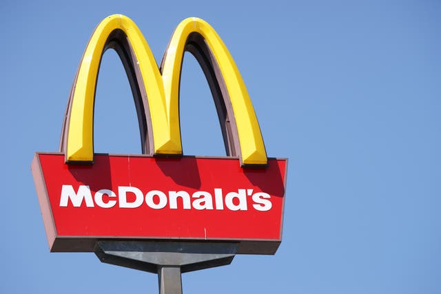 <p>Close-up of McDonalds outdoor sign with  typical rounded yellow M letter against cloudless blue sky</p>