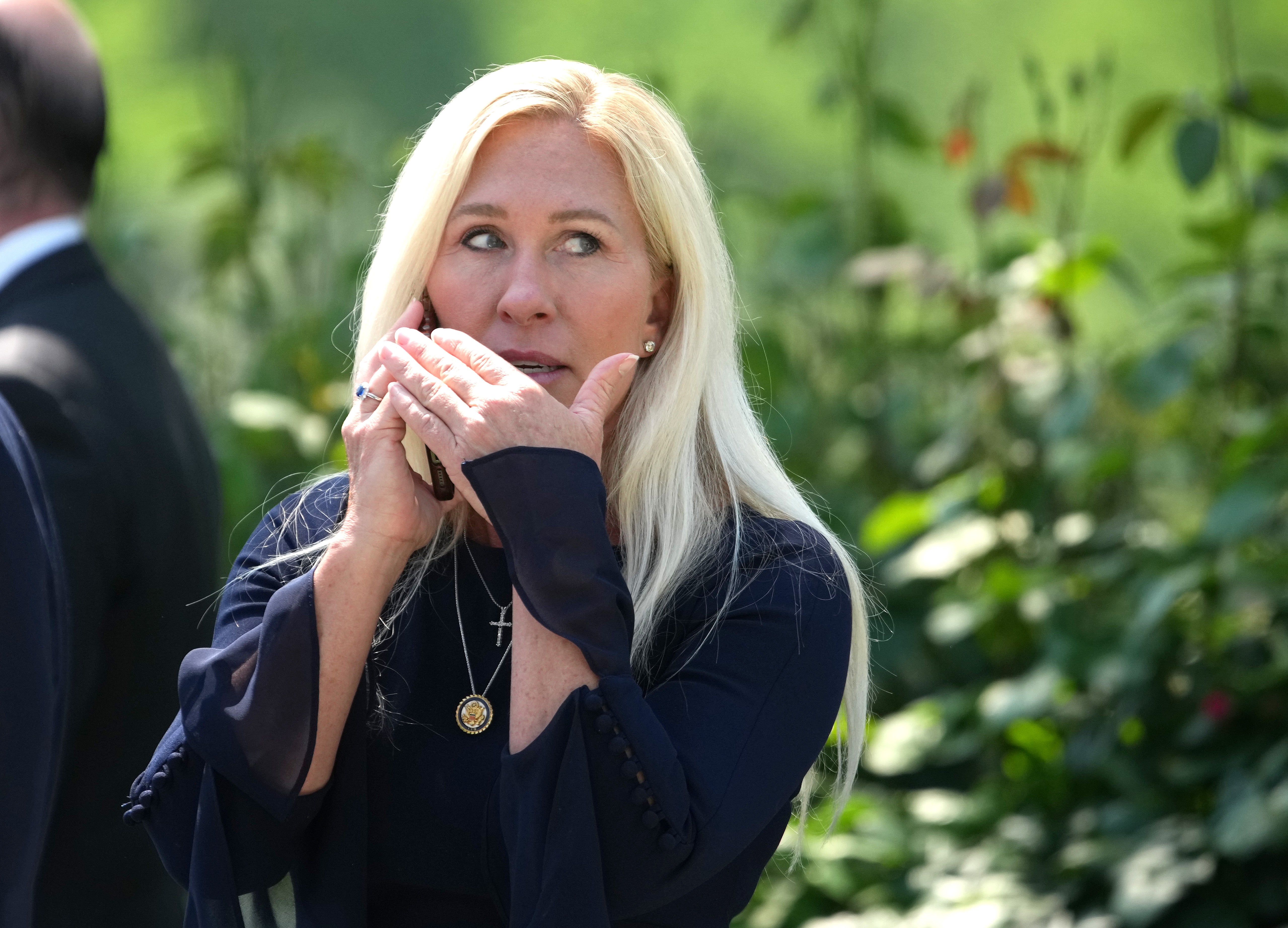Marjorie Taylor Greene talks on the phone during a National Day of Prayer event hosted by President Donald Trump in the Rose Garden at the White House on May 1, 2025, in Washington, DC. Greene has said that she’s considering a run for Senate or governor in Georgia